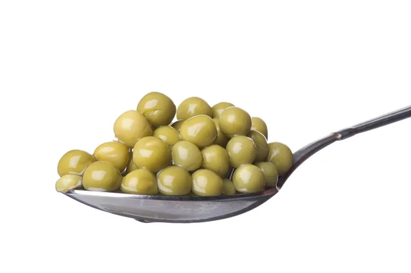 Green peas on spoon macro — Stock Photo, Image