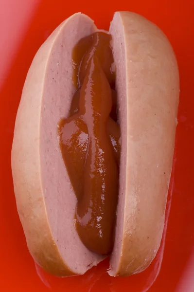 Sausage with ketchup macro — Stock Photo, Image