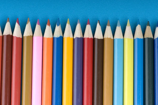Crayon on blue background — Stock Photo, Image