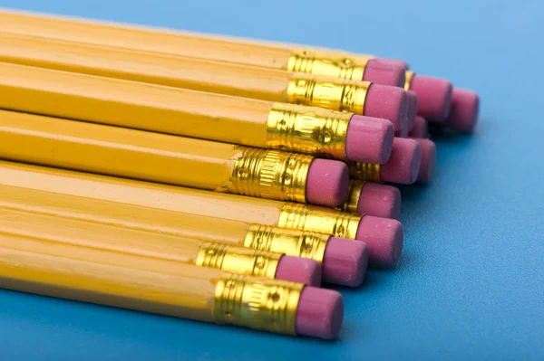 Crayon with eraser on blue close up — Stock Photo, Image