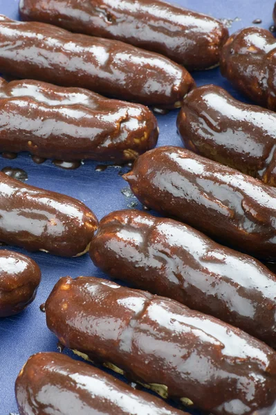Cooking eclair on blue — Stock Photo, Image