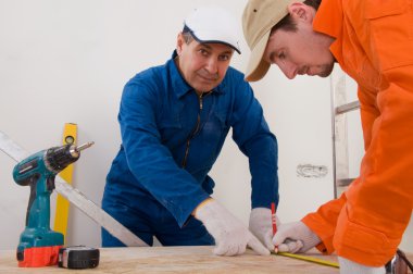 Construction worker doing measuring clipart