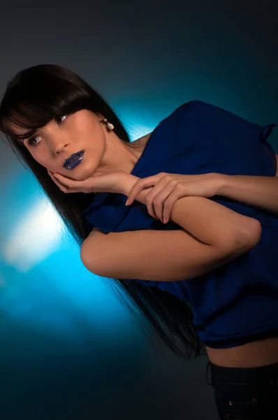 Портрет красивой молодой женщины на синем фоне — стоковое фото