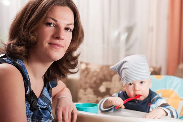 Portrait of young woman feeding her baby — Stock Photo, Image