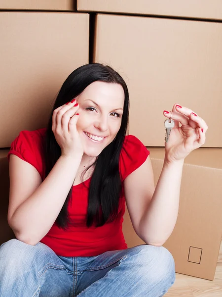 Woman sitting and holding cartons — Stock Photo, Image