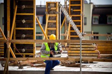 Construction worker working on a construction si clipart