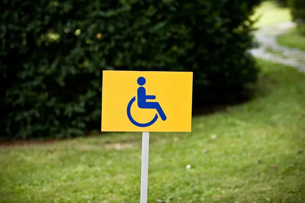 Behindertenschild auf Grashintergrund — Stockfoto