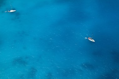 Boats on sea - top view with a lot of blue copy clipart