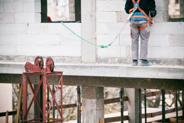 Construction worker working on a construction si clipart