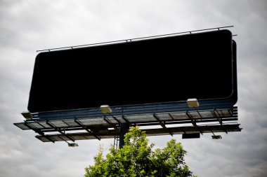 Black blank advertising billboard over sky clipart