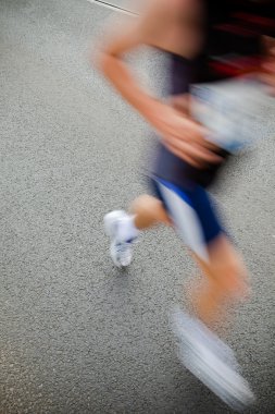 Man running in city marathon - motion blur clipart