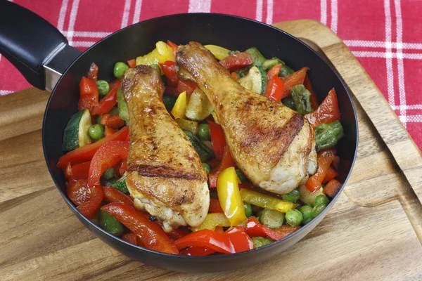 Stock image Chicken legs with fried vegetables