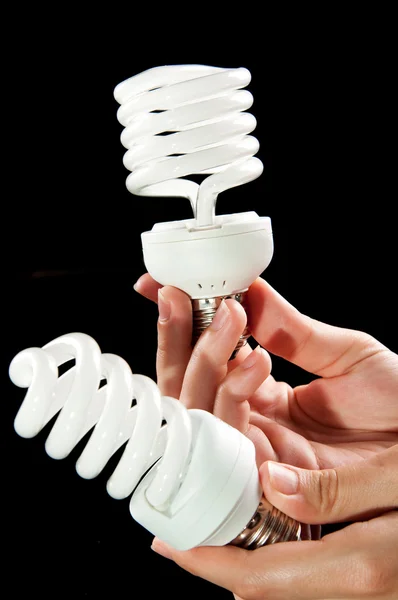 Energy saving light bulb in hand — Stock Photo, Image