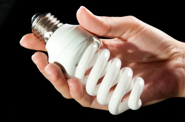 Bombilla de ahorro de energía en la mano —  Fotos de Stock