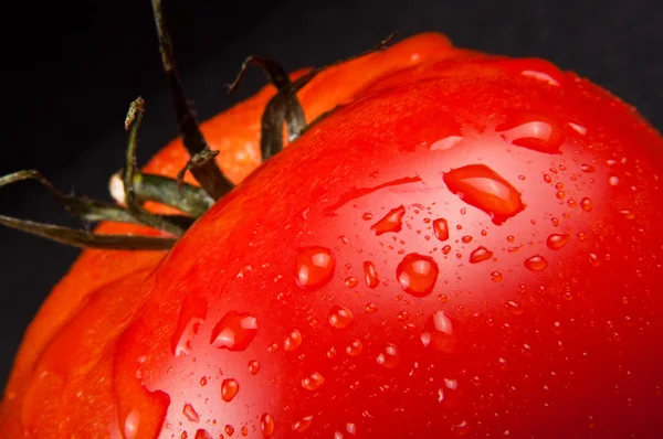 Fresh ripe tomato on black — Stock Photo, Image