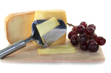 Cheese with a cheese slicer clipart
