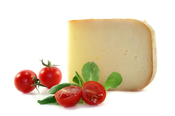 Piece of cheese with tomatoes — Stock Photo, Image