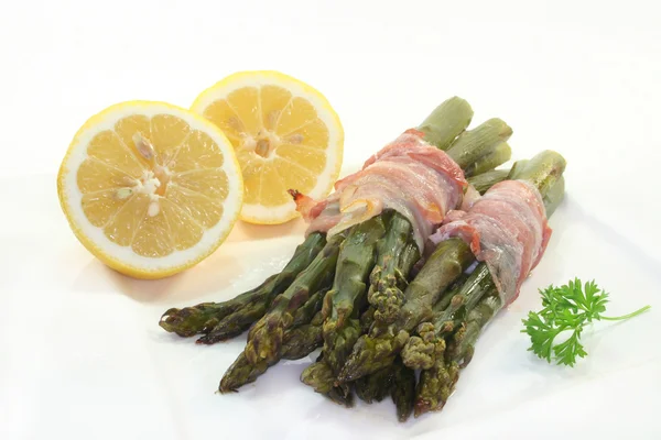 Green asparagus in bacon coat — Stock Photo, Image