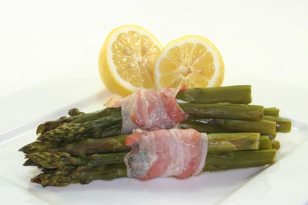 Green asparagus in bacon coat — Stock Photo, Image