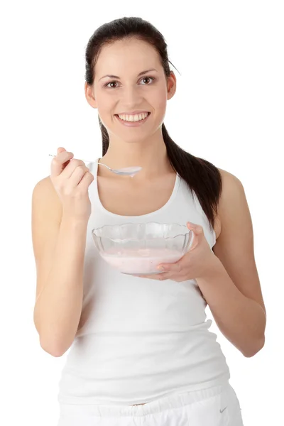 Female eating yoghurt — Stock Photo, Image