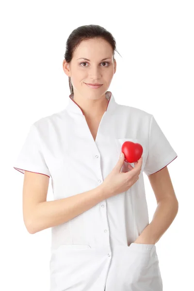 Młoda pielęgniarka z sercem w dłoni — Zdjęcie stockowe