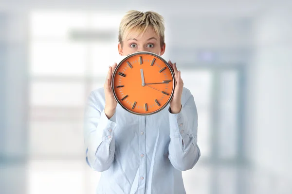 Woman holding big alarm clock — Stock Photo, Image
