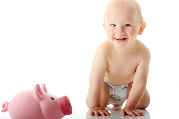 Young baby boy playing with pink piggy bank — Stock Photo, Image