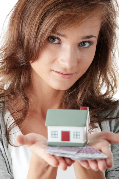 Young woman holding euros bills and house model — Stock Photo, Image