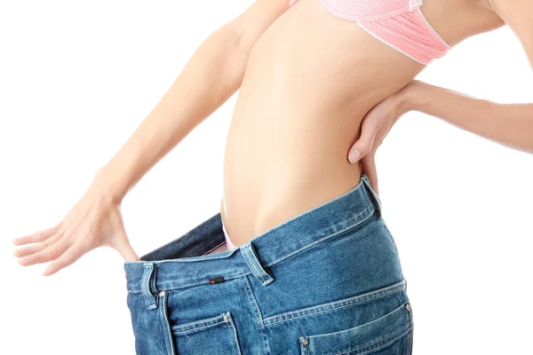 Kvinna visar hur mycket vikt hon gick ner. — Stockfoto