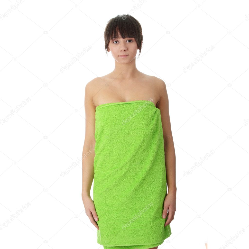 Attractive young nude woman in green towel