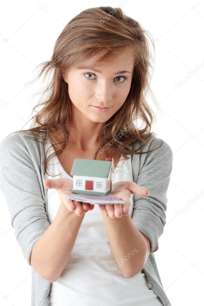 Woman holding euros bills and house model