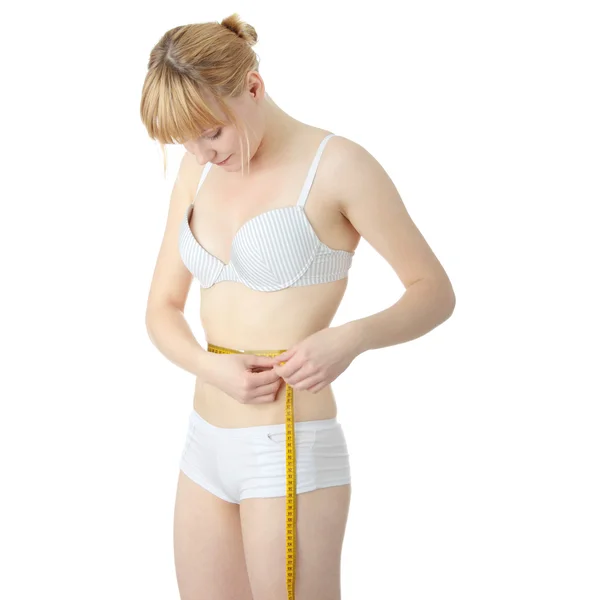 Sexy, em forma, jovem mulher medindo — Fotografia de Stock