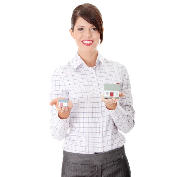 Young businesswoman holding two house models — Stock Photo, Image