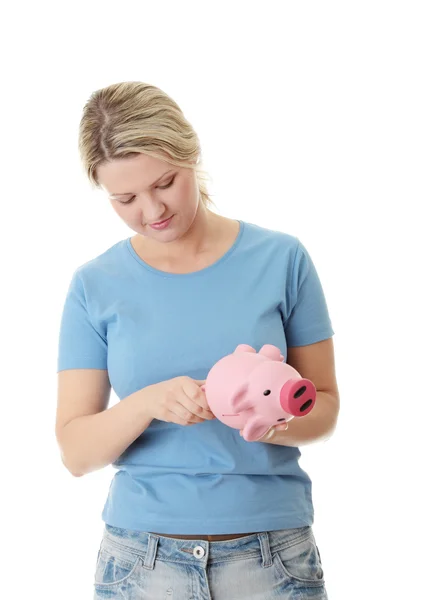 Trying to get money from piggy bank — Stock Photo, Image