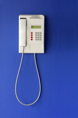 Wall phone on blue background clipart