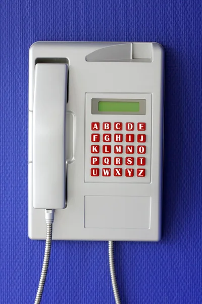 Wall phone with alphabet on red button — Stockfoto