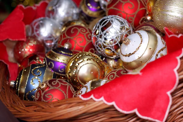 Christmas baubles in wicker basket — Stock Photo, Image
