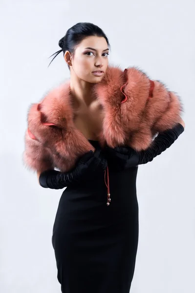 Young pretty girl in a fur pelerine — Stock Photo, Image