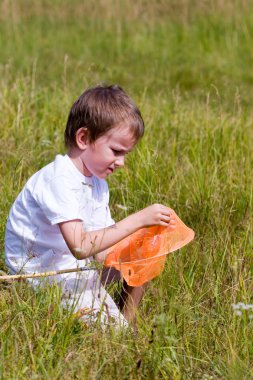 Boy catches a butterfly clipart