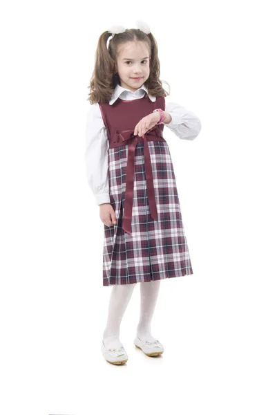 Malá školačka s růžové hodiny — Stock fotografie