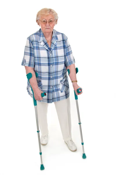 Old woman with crutches — Stock Photo, Image
