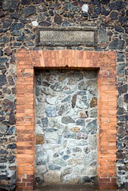 Stone wall with doors of medieval church clipart