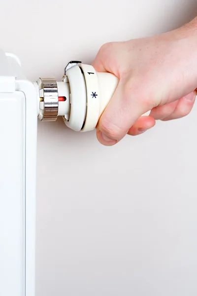 Men adjusting thermostat and radiator — Stock Photo, Image