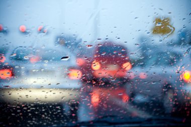 Car driving in a rain storm background clipart