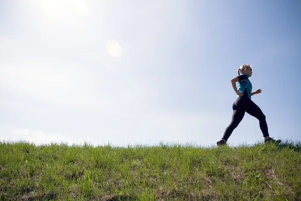 Young woman running outdoors, silhouette — Stock Photo, Image