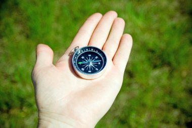 Man checking retro compass on trip clipart