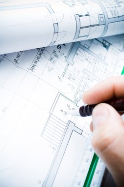 Architect working on blueprints clipart