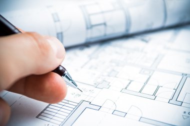 Architect working on blueprints clipart