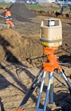 Theodolite on construction site clipart