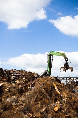 Metal recycling over blue sky clipart